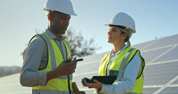 istock Engineering, teamwork and solar panels outdoor with electrician team planning, talking and working on maintenance, renewable energy and innovation. Man and woman engineer on photovoltaic energy 1448586158