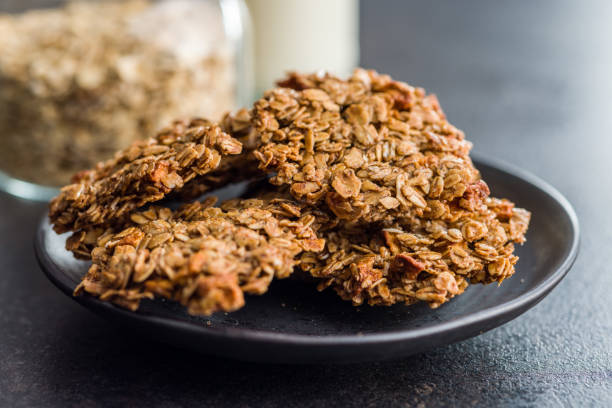 istock Sweet oatmeal cookies on plate on kitchen table. 1448587748