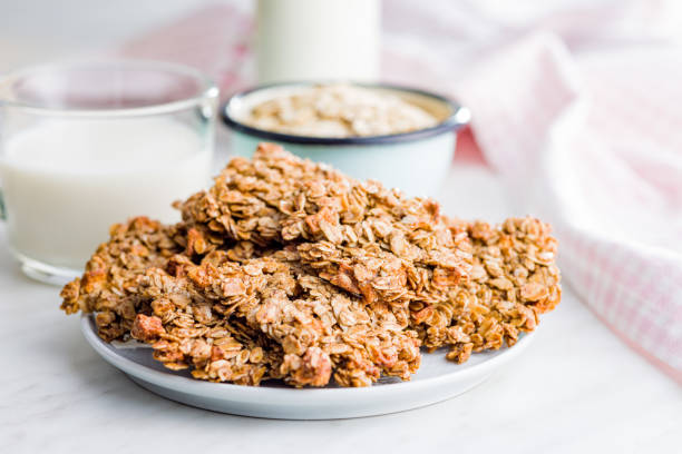 istock Sweet oatmeal cookies on plate on kitchen table. 1448587749