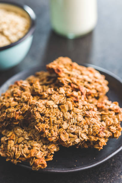 istock Sweet oatmeal cookies on plate on kitchen table. 1448587964