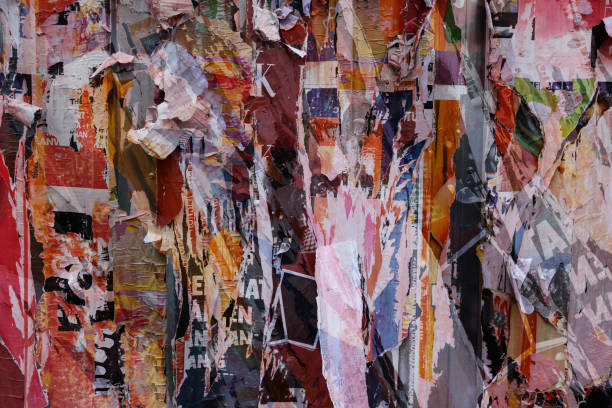 istock Pieces of torn paper peeling off wall used as billboard 1448590140