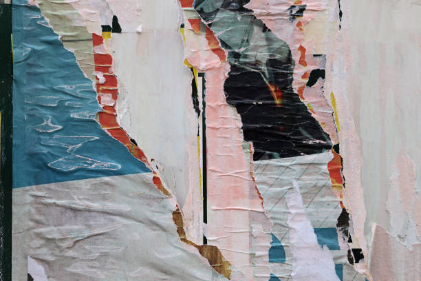 istock Pieces of torn paper peeling off wall used as billboard 1448591141