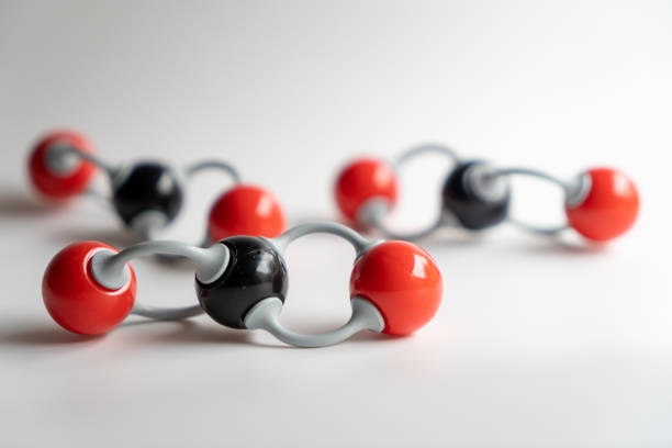 Close-up carbon dioxide molecule with two others carbon dioxide at the bottom. Chemical formula of CO2 made by molecular model.