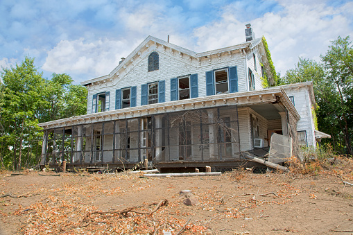 Abandoned old mansion circa 1920's - 30's, land cleared ready for demolition to make way for new development.