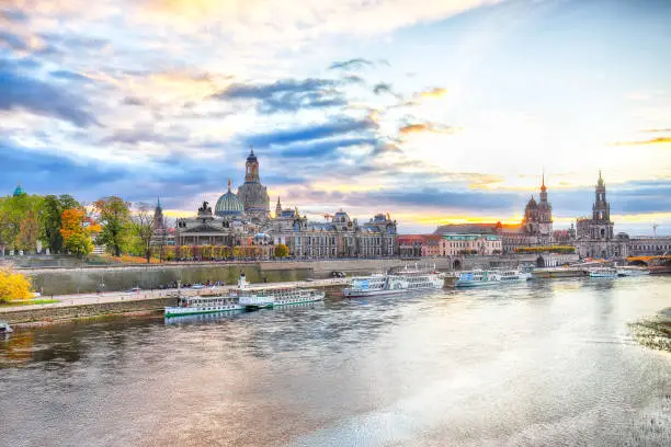 Sunset on Elbe river with panorama of Cathedral of the Holy Trinity or Hofkirche, Bruehl's Terrace or The Balcony of Europe Location: Dresden, state of Saxony, Germany, Europe