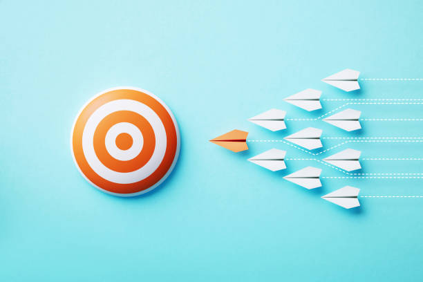 Paper Planes Moving Towards An Orange Bull's Eye Target On Blue Background