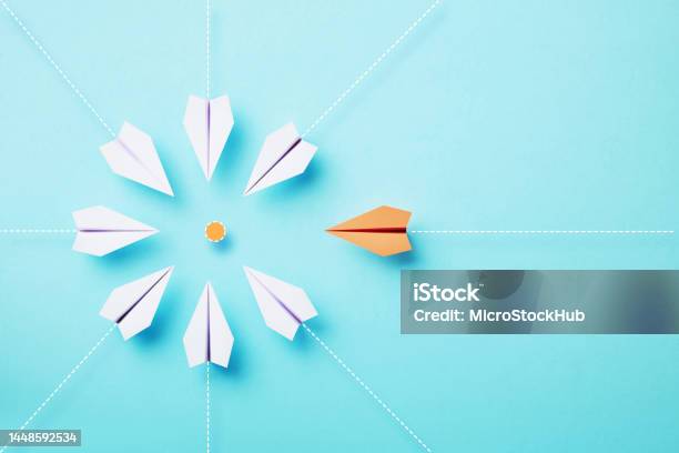Paper Planes Moving Toward An Orange Target On Blue Background Stock Photo - Download Image Now