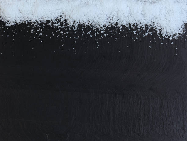 istock Border of Christmas snow on dark stone setting 1448592785