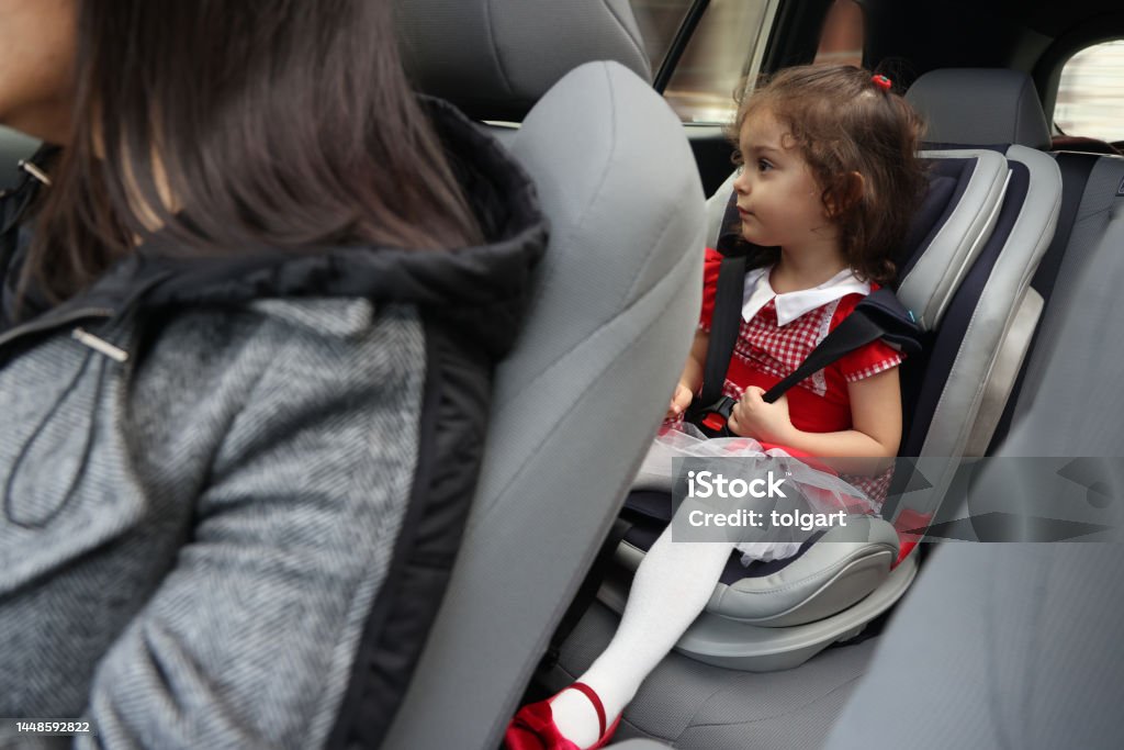 Cute little baby girl sitting in baby car seat. 2-3 Years Stock Photo