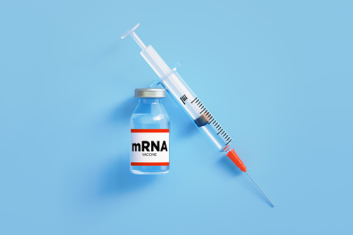 mRNA vaccine and syringe on blue background, Horizontal composition with copy space.