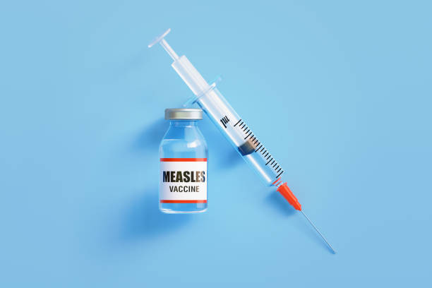 Measles Vaccine and Syringe On Blue Background Measles vaccine and syringe on blue background, Horizontal composition with copy space. measles stock pictures, royalty-free photos & images