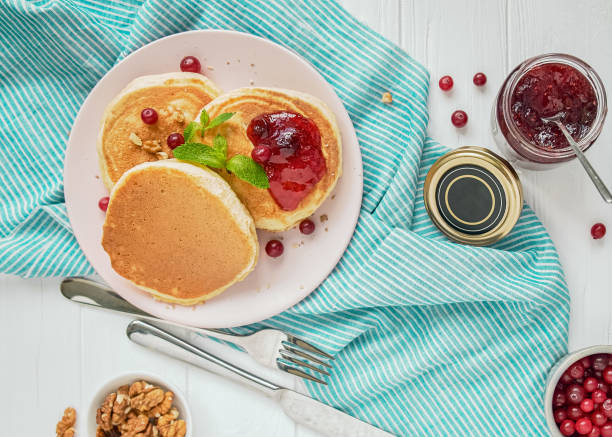 istock Pancakes with cranberry jam on a striped turquoise tablecloth, breakfast. 1448594934