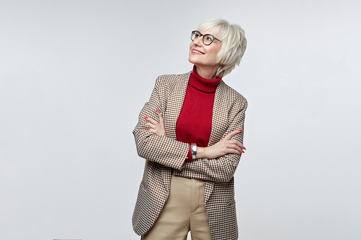 beautiful elderly woman with glasses looks at the free space. advertising concept of a business woman leader.
