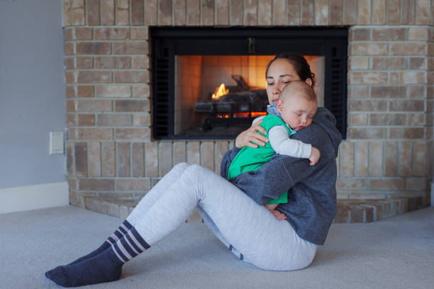 istock Baby sleeping in his mother's arms 1448597927