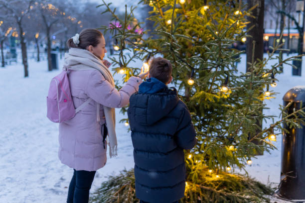 istock Mother with son standing near Christmas tree 1448598073