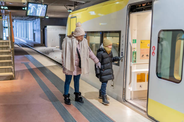 istock Mother with child entering in a subway train 1448598310
