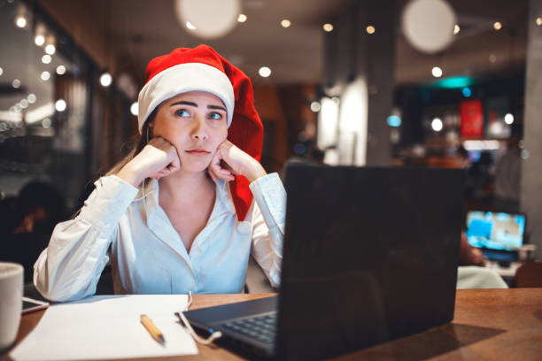 istock unhappy young woman working at christmas 1448601220
