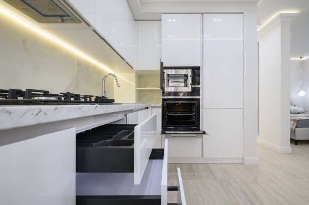 istock White modern kitchen with a stove, oven and microwave, drawers pulled out 1448603551
