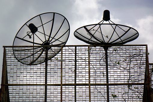 Close up satellite dishes on rooftop of residential building in Bangkok, Thailand
