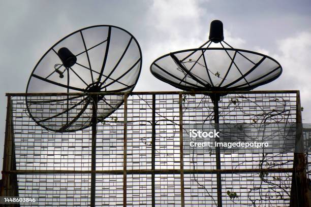 Satellite Dishes On Rooftop Of Residential Building Stock Photo - Download Image Now