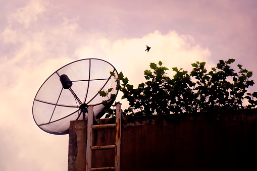 Close up satellite dish on rooftop of residential building in Bangkok, Thailand