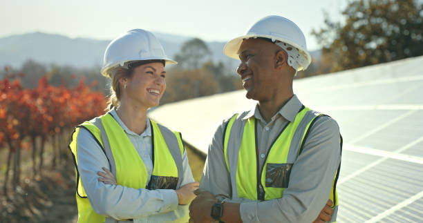 istock Engineer conversation, solar energy farm or happy diversity, teamwork and working together with laugh. Black man, woman and solar panel in sunshine, agriculture sustainability and eco friendly power 1448604947