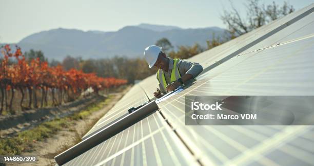 Black Man Engineer Or Solar Energy Management In Electricity Sustainability Solar Panels Or Sun Grid Plant Worker Employee Or Technician On Renewable Energy Farm Biodegradable Environment Or Eco Stock Photo - Download Image Now