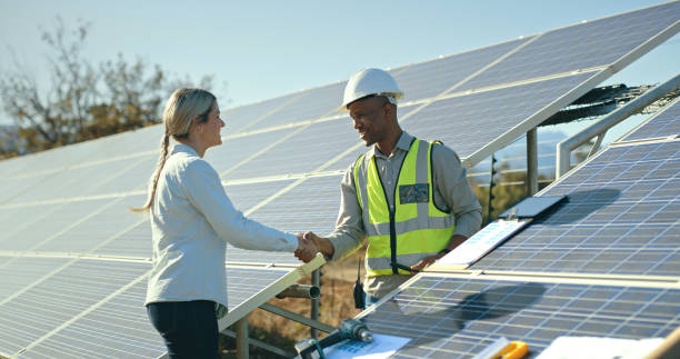 istock Construction, handshake and project management for solar panel installation, man and woman in agreement. Renewable energy, sustainability and solar energy engineer and customer shake hands on roof. 1448607402