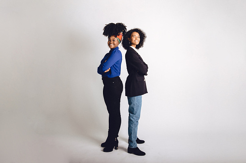 Multiracial group of two young beautiful female adults in a studio portrait photo.