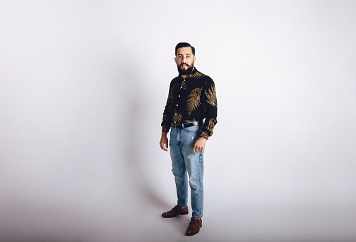 Young Middle Eastern male adult in a studio portrait photo.