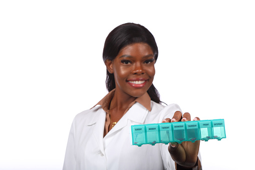African American Doctor Holds Pillbox to Camera