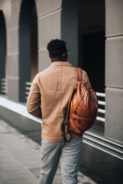 istock Black man pacing around the bus station while waiting for a bus 1448610825