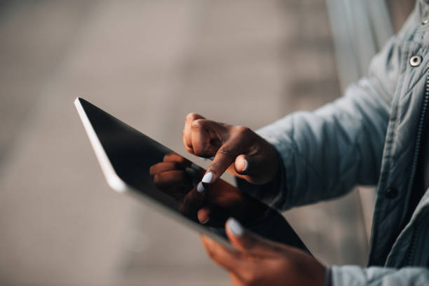 istock Close-up of a young black woman using tablet with blank screen 1448611416