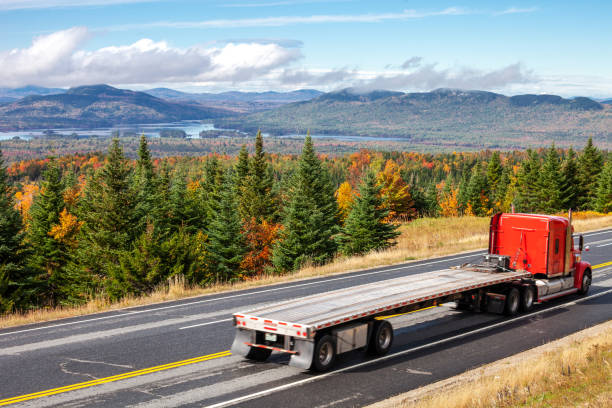 Colorful autumn landscape and a truck on road in northern Maine near Canadian border. USA