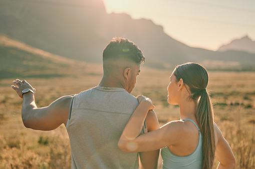 Fitness, talking and couple by the countryside to relax from sports training, hiking or field exercise workout in Mexico. Nature, love or healthy woman in conversation or speaking to partner on break