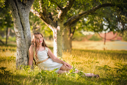 Cute small girl sitting on the grass
