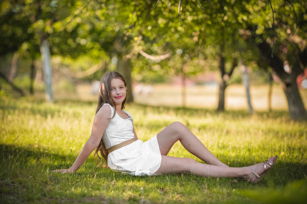 Cute small girl sitting on the grass