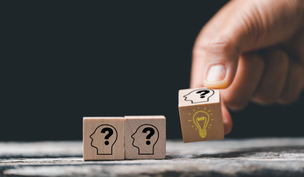 istock Concept creative idea and innovation. Hand choose wooden cube block with head human symbol and light bulb icon. knowledge and education concept. learning with smart technology. 1448621000