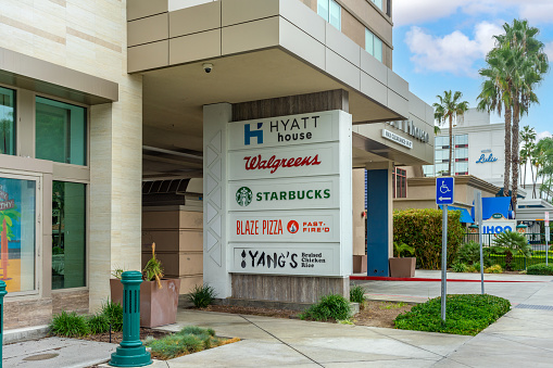 Anaheim, CA, USA – November 1, 2022: A multi-tenant sign at street level on a building on Harbor Blvd in Anaheim, California.