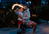 Dad and daughter celebrating the Fourth of July with fireworks