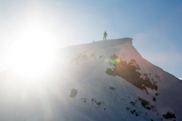 istock A tourist on a mountain top bathed in sunlight 1448621325
