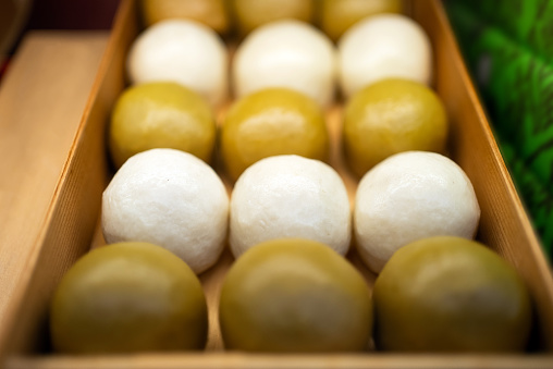 Souvenir manjuu in a wooden box.\nSweet bean-paste bun, Japanese traditional sweets.