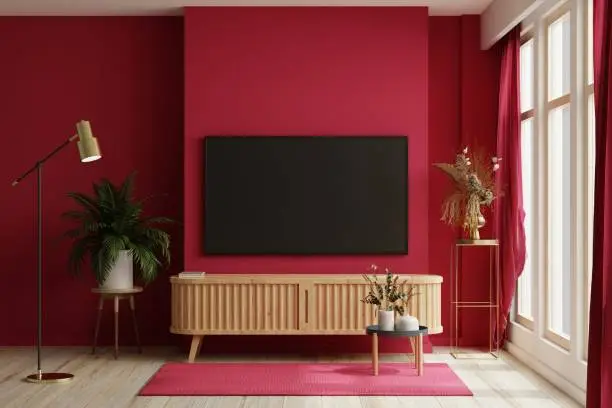 Photo of TV on the cabinet in modern living room on white viva magenta wall background.
