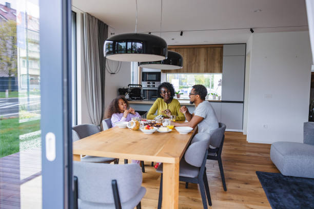 istock Black Family Having A Discussion While Eating Breakfast In A Beautiful Modern Apartment 1448623366