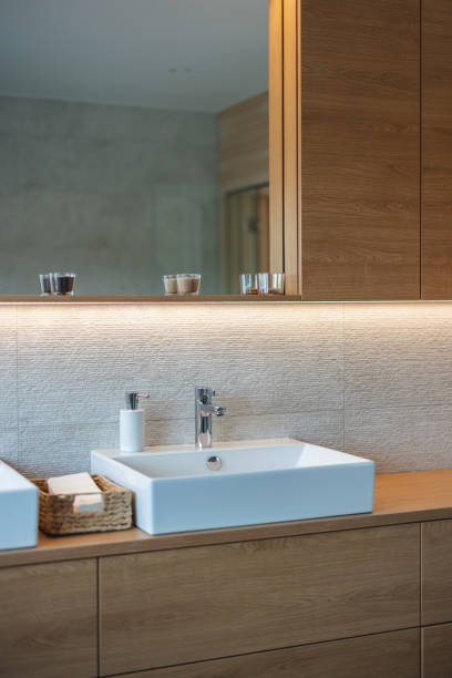 istock Modern Bathroom Interior With Wooden Cabinets And White Sink 1448623853