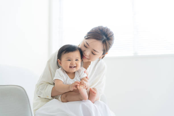 istock Baby and mother relaxing at home 1448629833