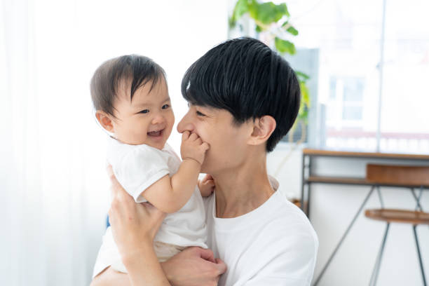 istock Baby and dad having fun at home 1448630069