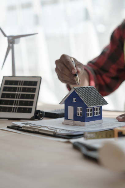 istock Wind turbine, Professional engineering solar planning blueprint for clean energy house at architectural office, Renewable Energy and Solar Energy Electrical Engineer concept. 1448631945