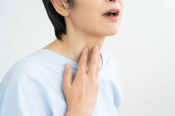 istock Woman suffering from sore throat 1448632410