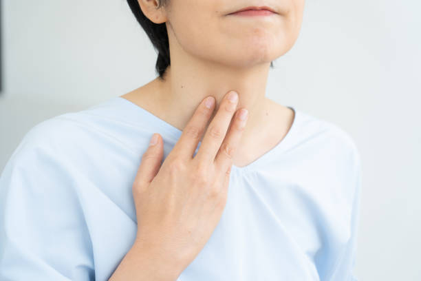istock Woman suffering from sore throat 1448632420